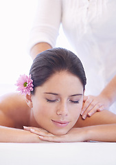 Image showing Relax, massage and woman at wellness spa with flower for health, rest and luxury holistic treatment. Self care, peace and girl on table with masseuse for body therapy, balance and calm hotel service