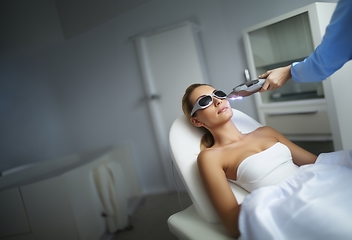 Image showing Modern woman undergoes laser hair removal therapy, embracing contemporary beauty techniques for smooth and hair-free skin.