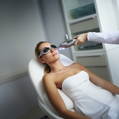 Image showing Modern woman undergoes laser hair removal therapy, embracing contemporary beauty techniques for smooth and hair-free skin.