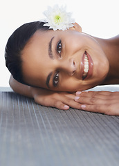 Image showing Flower, relax or portrait of happy woman in spa for wellness, cosmetics or hospitality in hotel. Calm peace, smile or person in resort on break or holiday vacation for beauty, skincare or health