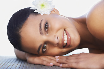 Image showing Flower, relax or portrait of happy woman in resort for wellness, cosmetics or hospitality in hotel. Calm peace, smile or person in spa on break or holiday vacation for beauty, skincare or health