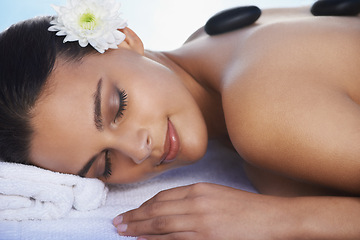 Image showing Sleeping, hot stone or woman with flower in spa for wellness, treatment or hospitality. Relax, resort or salon with female person, client or masseuse in hotel on holiday vacation for beauty therapy