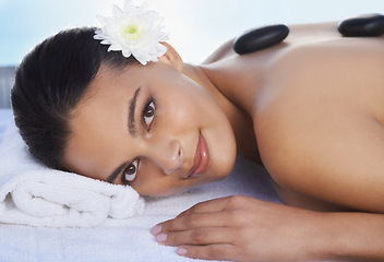 Image showing Sleeping, hot stone or woman in spa with smile or flower for wellness, treatment or hospitality. Relax, resort or healing therapy for happy person, client or masseuse in hotel on holiday vacation