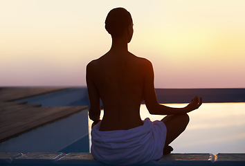 Image showing Back, yoga and woman meditate at sunset by swimming pool for healthy body, wellness and zen outdoor on mockup space. Rear view, lotus pose and silhouette of person at twilight to relax, peace or calm