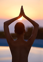 Image showing Tree, yoga and woman meditate at sunset by swimming pool for healthy body, wellness and zen outdoor. Rear view, vrikshasana pose and person at water at twilight to relax, peace or calm for balance