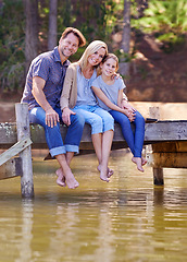 Image showing Portrait, lake and girl with family, smile and happiness with water or nature with vacation or getaway trip. Parents, hug or mother with father or child in a forest or holiday with boardwalk or relax