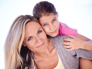 Image showing Mother, daughter or portrait with piggyback in studio for bonding, support or hug on holiday with smile. Family, woman and girl child with face, happy or embrace with love or care on white background