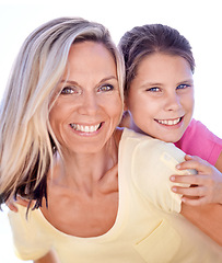 Image showing Mother, girl child or portrait with piggyback in studio for bonding, support or hug on holiday with smile. Family, woman and daughter with face, happy or embrace with love or care on white background