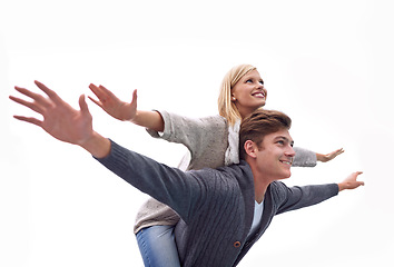 Image showing Couple, piggy back and airplane with arms, smile and funny game with care for connection with bonding outdoor. Man, woman and playful with plane, wings or flight for freedom on journey for vacation