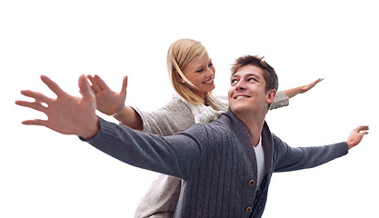 Image showing Couple, piggy back and plane with arms, smile and games on date with care for connection on Valentines day. Man, woman and playful with airplane, wings or flight for freedom on journey for vacation