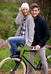 Image showing Couple, portrait and park with retro bicycle on holiday, adventure and date with sustainable transport. Man, woman and vintage bike with smile for holiday with journey in woods, path or environment