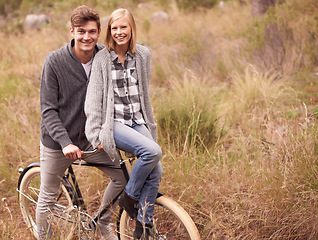 Image showing Couple, portrait and field with retro bicycle on holiday, adventure or date with sustainable transport. Man, woman and vintage bike with smile for vacation with journey in nature, path or environment