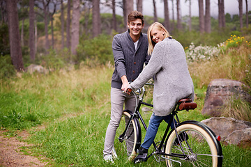 Image showing Couple, portrait and forest with retro bicycle on holiday, adventure and date with sustainable transport. Man, woman and vintage bike with smile for holiday with journey in woods, path or environment