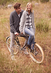 Image showing Couple, happy and field with retro bicycle on holiday, adventure or date with sustainable transport. Man, woman and vintage bike with smile for vacation with journey in nature, path or environment