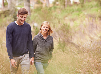 Image showing Happy couple, walk and holding hands in nature, forest or summer outdoor for hiking on valentines day date. Smile, man and woman in the countryside for support, love or romantic connection together