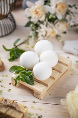 Image showing Elegant bath bombs arranged on a wooden tray