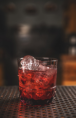Image showing Elegant glass of red cocktail on bar counter