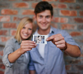 Image showing Hands, photograph and couple on wall blurred background together for love, bonding of memory of past. Portrait, smile or happy with young man and woman holding picture for romance or nostalgia