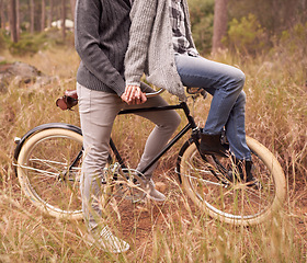 Image showing Couple, outdoor and bike with handlebars for carrying person for adventure, vacation or sustainability. People, retro bicycle and nature and path for cycling journey on holiday with ecology in woods