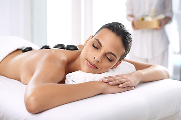 Image showing Nap, hot stone and woman with massage at spa for wellness, health and back treatment. Self care, cosmetic and young female person sleeping for warm rock skin therapy at natural beauty salon.