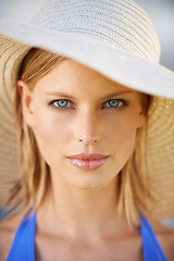 Image showing Woman, portrait and confidence with hat in summer for holiday, vacation and adventure with swimwear. Person, face and attitude for relax, swimming and fun in nature on weekend for travel break