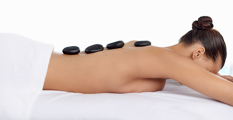 Image showing Health, hot stone and woman with massage at spa for wellness, natural and back treatment. Self care, cosmetic and calm young female person sleeping for warm rock skin therapy at beauty salon.