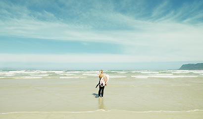 Image showing Beach, sky or space and woman with surfboard outdoor in summer for travel, sports or seascape view. Water, training and sand with surfer person by sea or ocean for fitness or exercise from back