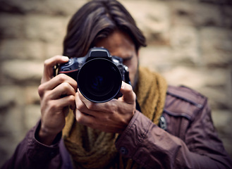 Image showing Photographer, work and man in city as paparazzi, filming and memory of travel or adventure for press. Professional, cameraman and person capture creative photography with lens outdoor in photoshoot