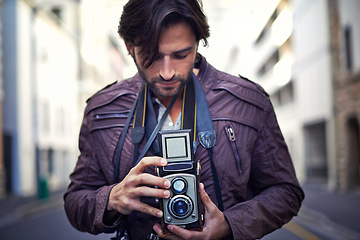 Image showing Retro, camera and photographer in city for photoshoot with professional gear to film on street. Travel, photography and creative cameraman with vintage lens to capture urban media outdoor on road