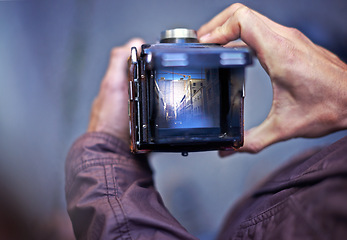 Image showing Vintage, camera and photography on screen in hands of person with photoshoot in city to film street. Travel, photographer and creative cameraman closeup with retro lens to capture urban media outdoor