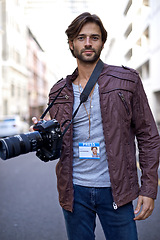 Image showing Press, photographer and portrait with camera outdoor in city for photoshoot with gear to film on street. Travel, photography and creative cameraman shooting with lens to capture urban media on road