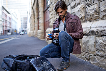 Image showing Camera lens, equipment and photographer in city for photoshoot with gear on street. Cameraman, cleaning and prepare professional photography tools for project and person with technology on road