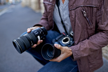 Image showing Camera lens, outdoor and hands of photographer to work in city on photoshoot with professional gear to film on street. Shooting, photography and cameraman closeup with tech to capture media in town