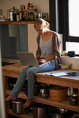 Image showing Woman in kitchen, laptop and remote work, typing for blog with freelancer and copywriting. Working from home, website development and writing article with technology and copywriter research online
