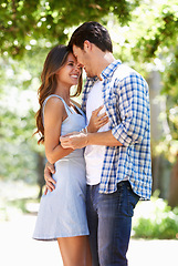 Image showing Couple, hug and happy in park with love in summer for partnership together or date, laughing or embrace. Man, woman and bonding in nature backyard for relationship vacation or sun, holiday or trees