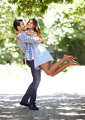 Image showing Man, woman and hug spin or outdoor or fun relationship in park for summer partnership, together or laughing. Happy couple, embrace and love with trees or nature adventure in marriage, date or bonding