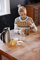 Image showing Woman, kitchen and herbal tea in home for health and warm drink with plant leaf mixture for wellness. Above, designer and morning with dried leaves in plunger and calm for detox beverage in apartment