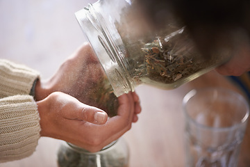 Image showing Hands, jar and tea leaves for herbal drink in kitchen for healthy benefits for beverage or hibiscus, jasmine or preparation. Person, fingers and chamomile for peaceful morning, vitality or wellness