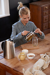 Image showing Woman, happy and tea of herbs in home and warm beverage of herbal mixture for health wellness. House, homeopath and detox with dry leaves in plunger and chamomile drink to relax in kitchen by table