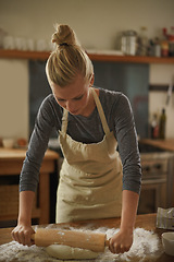 Image showing Woman, baking and rolling pin in a kitchen with flour and dough for bread in a home. Food, relax and cooking a dessert in a house with wheat powder, nutrition and lunch recipe on a table with a baker