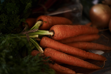 Image showing Closeup, carrot and food for health and cooking, wellness and nutrition with vegan or vegetarian meal prep. Orange vegetables, organic produce and cuisine with dinner or lunch ingredients for diet