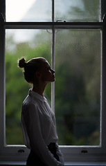 Image showing Woman, window and thinking in home or dark in evening with anxiety or mental health, depression or thoughts. Female person, apartment and environment view or upset wondering for sad, grief or London