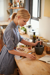 Image showing Cooking, woman and mortar with grind in a home with diet, nutrition and healthy food with pestle. Kitchen, bowl and happy from organic and vegan lunch with mushroom and wood board with wellness