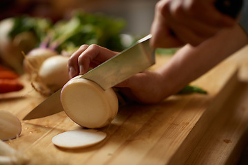 Image showing Person, hands and turnip chop for salad with knife, wellness and health in a home for nutrition. Vegan, wood board and cooking with diet food in a kitchen with vegetable ingredients for lunch recipe