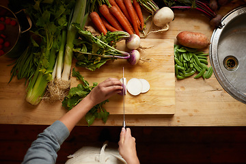 Image showing Cutting, board and hands with vegetables for healthy food, cooking or preperation of soup ingredients on table. Chef or person above in kitchen with organic groceries and potato for a vegan dinner