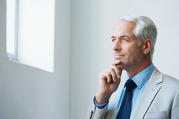 Image showing Thinking, mature and businessman at office in suit, looking at window and confident with thoughts. Corporate, executive and professional with experience in business with wisdom and ideas for future