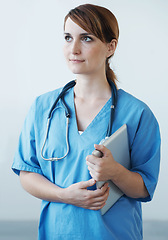 Image showing Nurse, woman and thinking with tablet in studio for healthcare, wellness and medic for medicare. Female medical physician, digital touchscreen tech and professional nursing expert for telehealth
