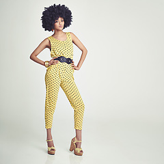 Image showing Black woman, portrait and retro fashion in studio for vintage, unique look and jumpsuit. African girl, stylish and gen x with curly hair afro, confident and pose with white background for mockup