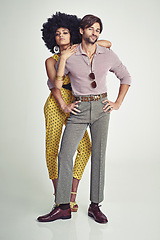 Image showing Couple, portrait and fashion in confidence for style, outfit or clothing on a gray studio background. Young interracial man and woman in stylish retro or vintage pants, shirt or jumpsuit with jewelry