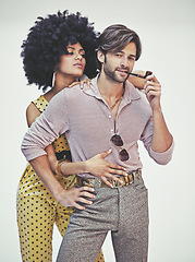 Image showing Couple, portrait and fashion with pipe for smoking, style or outfit on a gray studio background. Young interracial man, woman or smoker in stylish pants, shirt or jumpsuit with jewelry or accessories